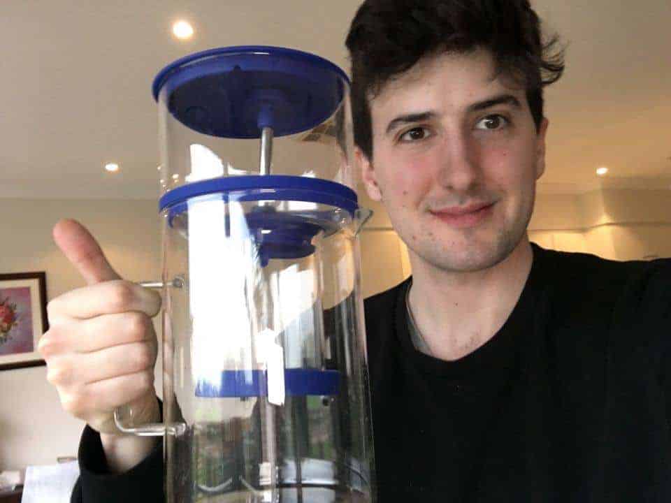 Cold Drip Coffee Maker Held By Barista