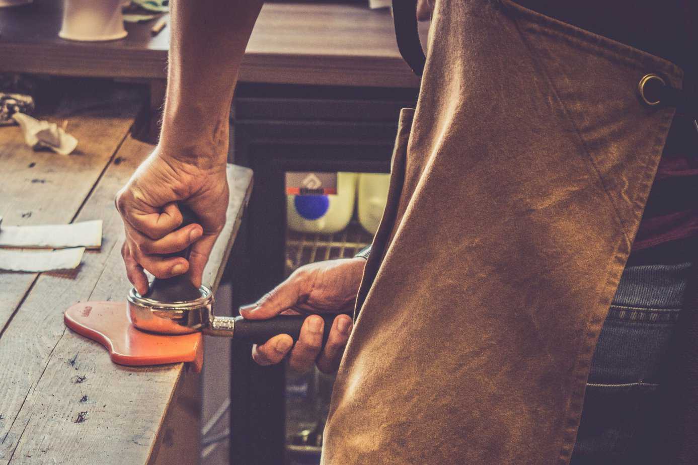 Tamping with barista apron